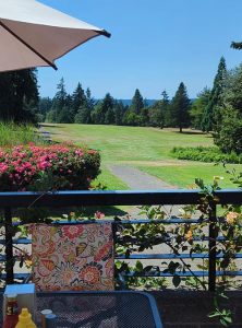 A view from the restaurant outdoor seating of the golf greens and Puget Sound.