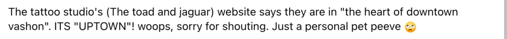Screenshot of a webpage text noting a tattoo studio claiming to be in the heart of downtown Vashon but saying 'UPTOWN', with an apologetic tone and an eye-roll emoji.